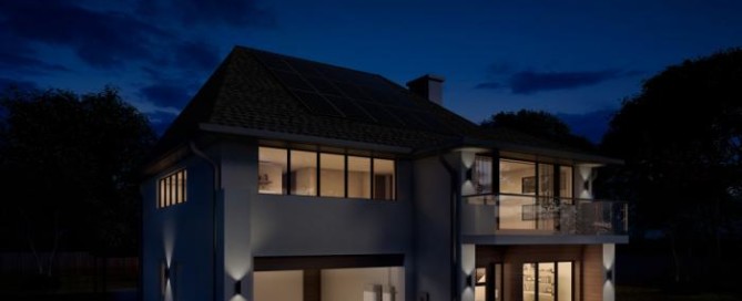 Precis Solar installed on a home with lights on at night.