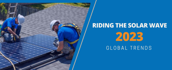 Riding the solar wave 2023 global trends. Two workers installing solar panels on top of a roof.